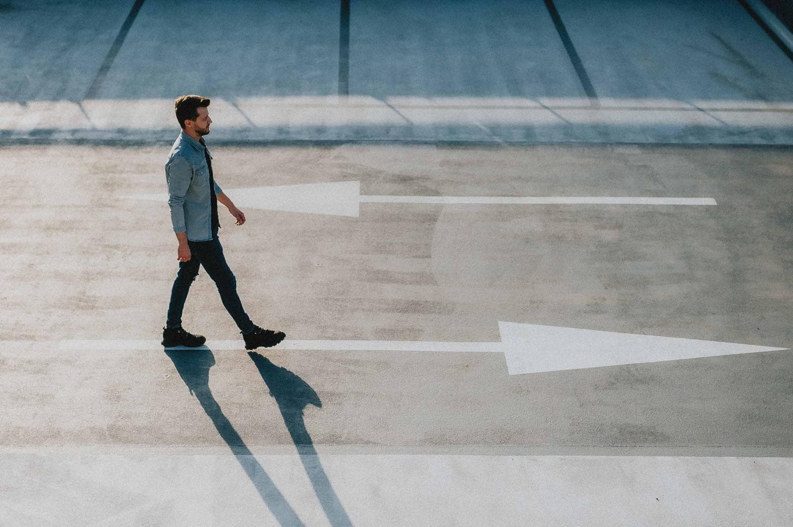 Person walking over arrows painted on the ground